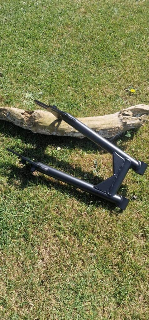Motorcycle swing arm with axle adjuster plates in Cerakote Graphite Black H-146 frame coating